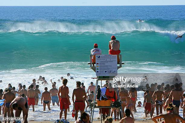 Anglet , supervised swimming in summer, crowd along the water's edge an lifeguards keeping a watchful eye. Waves and surfing.