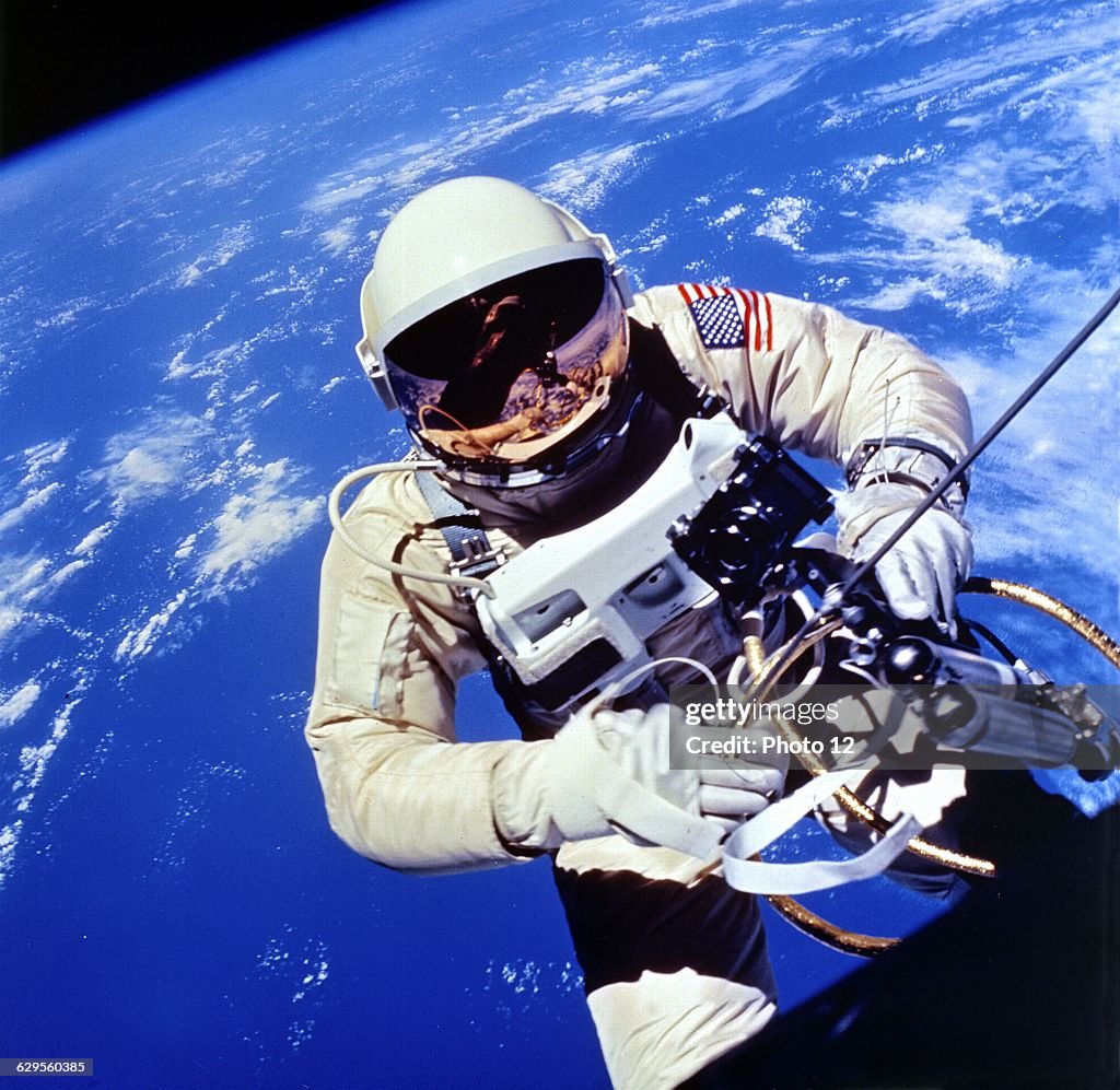 Photograph showing US Astronaut Edward H. White II carrying out external tasks during third orbit of Gemini-Titan 4 flight