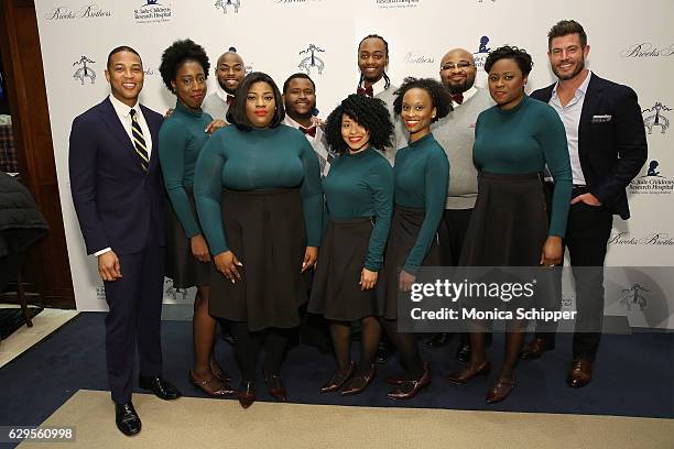 Don Lemon and Jesse Palmer pose with the boys and girls choir of Harlem at an evening hosted by Brooks Brothers to celebrate the holidays with St....