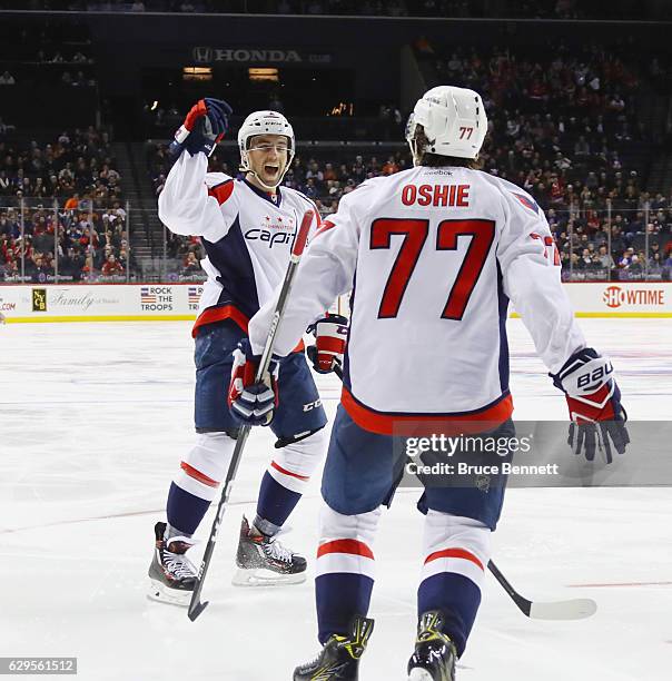 Matt Niskanen of the Washington Capitals celebrates his goal at 1:34 of the third period against the New York Islanders and is joined by T.J. Oshie...