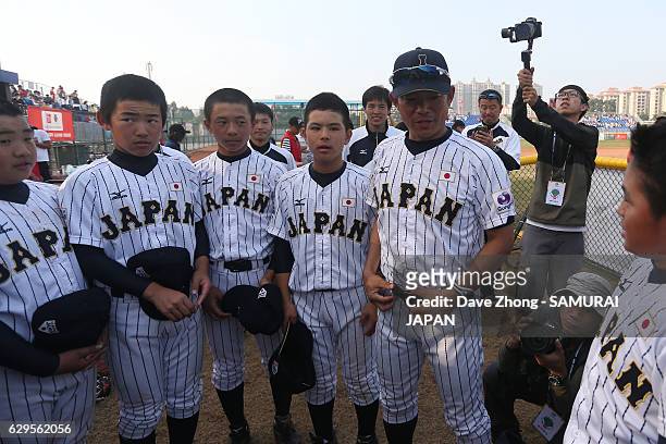 Manager Nishi Toshihisa of Japan talks to players after winning the 2016 IX BFA U12 Baseball Championship final game between Japan and Korea at Panda...