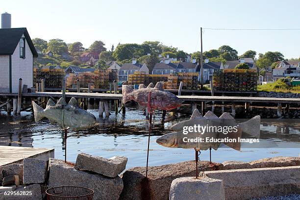 Cod fish weathervanes on waterfront Vinalhaven Island Maine New England USA.