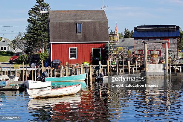 Lobster shack with small boats on waterfront Vinalhaven Island Maine New England USA.