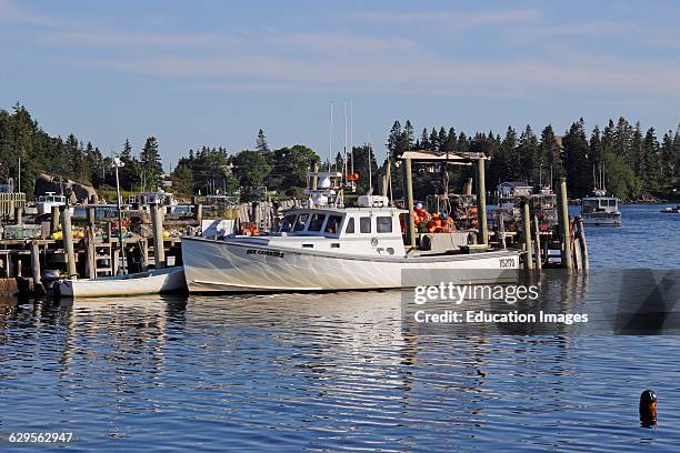 Lobster boat at dock waterfront Vinalhaven Island Maine New England USA.