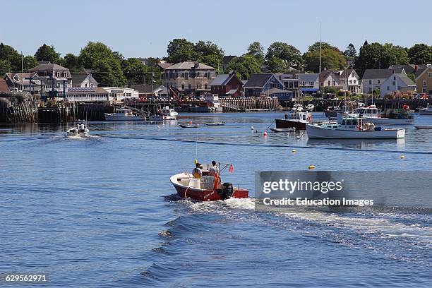 Lobster boat returning to dock waterfront Vinalhaven Island Maine New England USA.