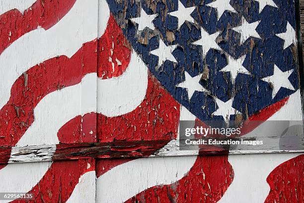 American flag painted on peeling door Vinalhaven Island Maine New England USA.
