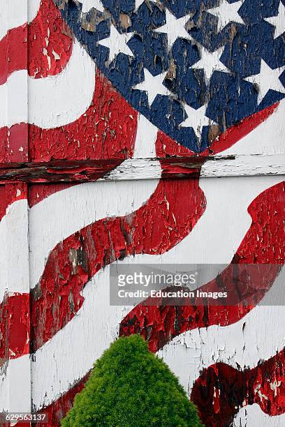 American flag painted on peeling door Vinalhaven Island Maine New England USA.