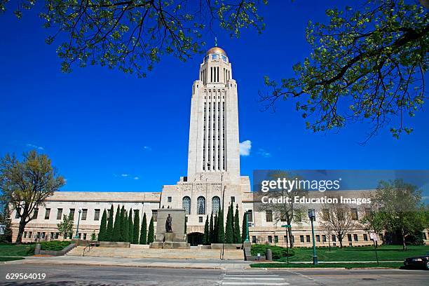State capitol building in Lincoln Nebraska on a sunny spring day and emphasizing the buildings tall central tower and dome, Lincoln, the capital...