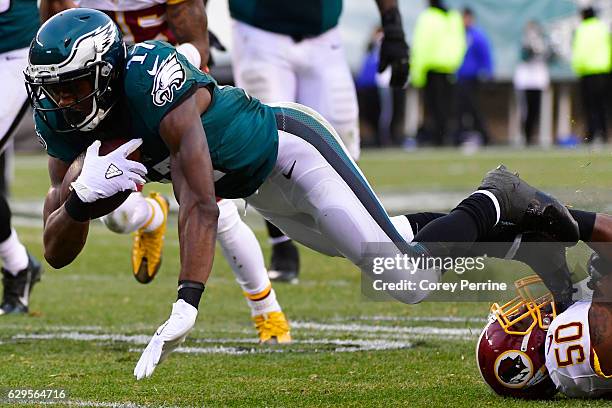 Nelson Agholor of the Philadelphia Eagles is tackled by Martrell Spaight of the Washington Redskins during the fourth quarter at Lincoln Financial...