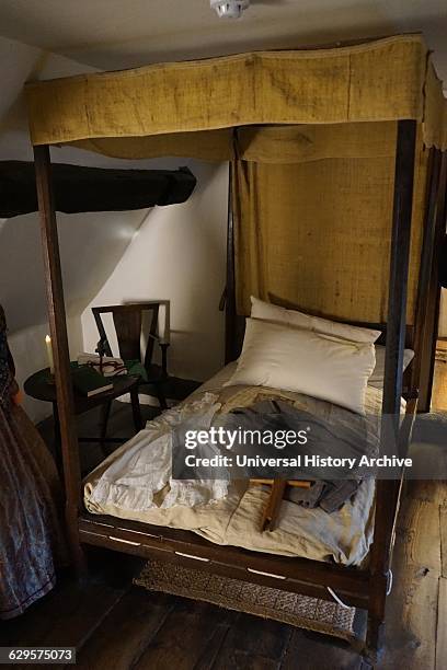 Bed with wool jacket at Anne Hathaway's Cottage, where Anne Hathaway, the wife of William Shakespeare, lived as a child. Stratford-upon-Avon,...