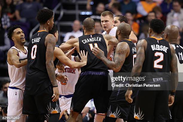 Kristaps Porzingis of the New York Knicks is restrained from Marquese Chriss of the Phoenix Suns after a confrontation during the second half of the...