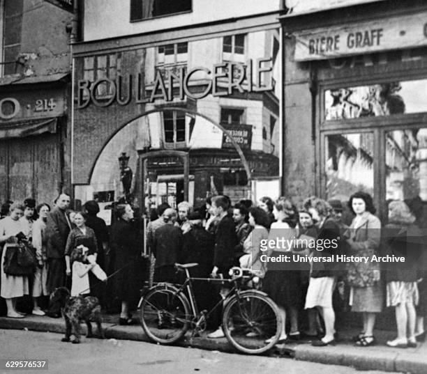 Parisians queue at a boulangerie in Paris during the German occupation in World war two 1941