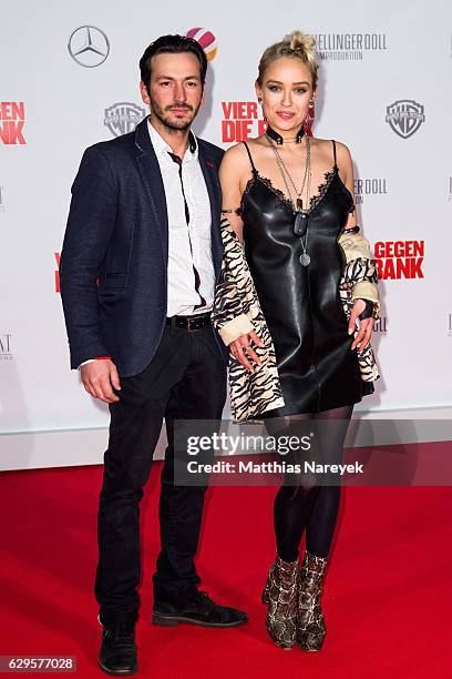 Arnel Taci and Caro Cult attend the German premiere of the film 'Vier gegen die Bank' at CineStar on December 13, 2016 in Berlin, Germany.