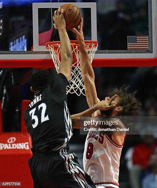 Robin Lopez of the Chicago Bulls blocks a shot by Karl-Anthony Towns of the Minnesota Timberwolves despite getting a hand in his face at the United...