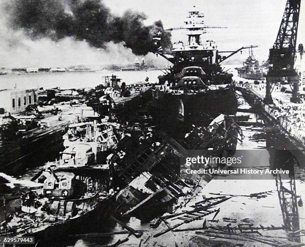 Pennsylvania, behind the wreckage of the USS Downes and USS Cassin after the attack on Pearl Harbour. Surprise military strike by the Imperial...