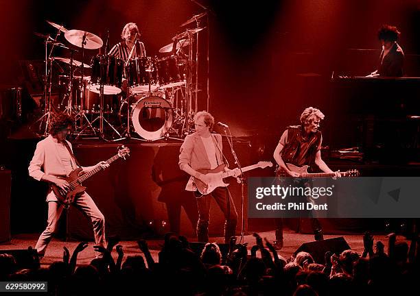 Dire Straits perform on stage in Guildford, 1982. L-R John Illsley, Terry Williams, Mark Knopfler, Hal Lindes, Alan Clark.