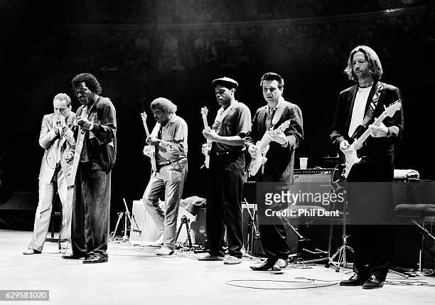 Eric Clapton performs on stage with blues musicians at the Royal Albert Hall, London, 1991. L-R Jerry Portnoy, Buddy Guy, Albert Collins, Robert...