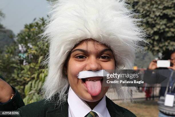School child shows his tongue in emulating the famous pose by Albert Einstein at the world's single largest gathering of 550 Nobel Laureate Albert...