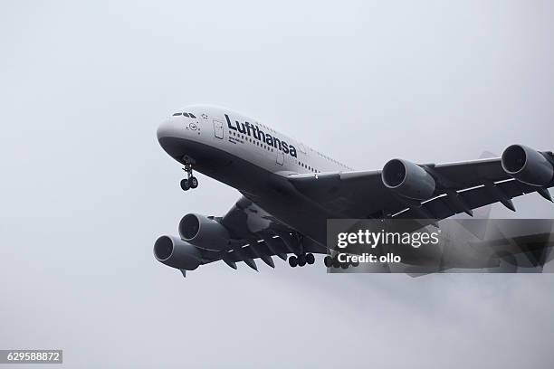 landing approach of lufthansa airbus a380 in the fog - airbus a380 stock pictures, royalty-free photos & images