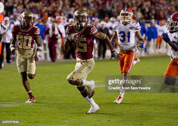 Florida State WR Travis Rudolph runs away from Florida defenders for a touchdown during the NCAA football game between the Florida State Seminoles...