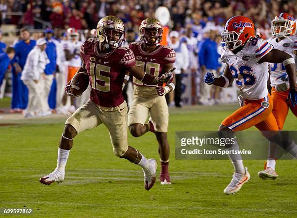 Florida State WR Travis Rudolph runs away from Florida defensive back Marcell Harris for a touchdown during the NCAA football game between the...