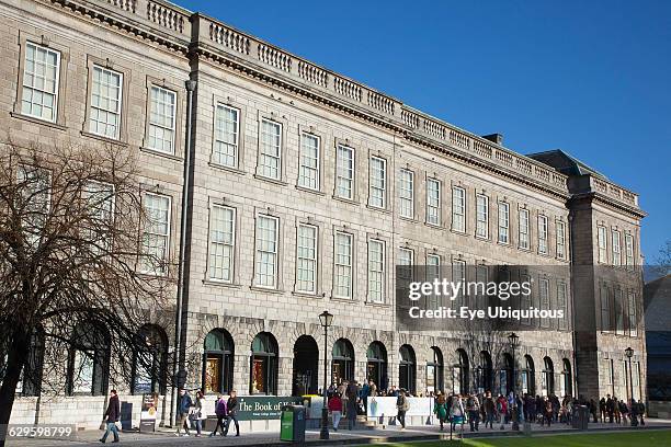 Ireland, Dublin, Trinity College buildings on College Green, Tourists queueing to enter the library to see the Book of Kells.