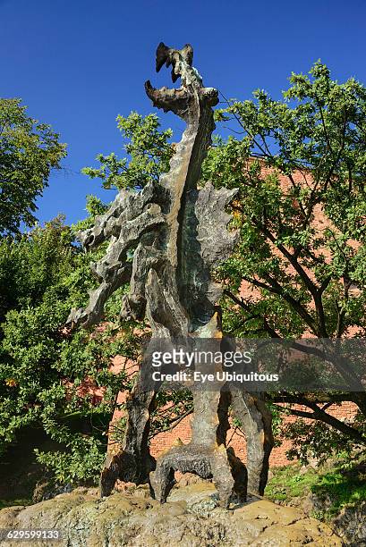 Poland, Krakow, Statue of the Wawel Dragon outside Smocza Jama or the Dragon's Den below Wawel Hill.