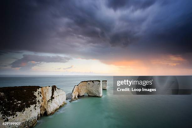 Stormy sunrise over Old Harry Rocks near Swanage in Dorset, Swanage, England.