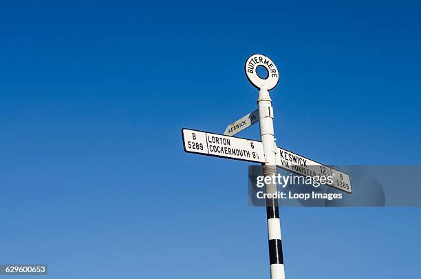 Road sign at Buttermere giving directions to Lorton, Cockermouth and Keswick, Buttermere, England.