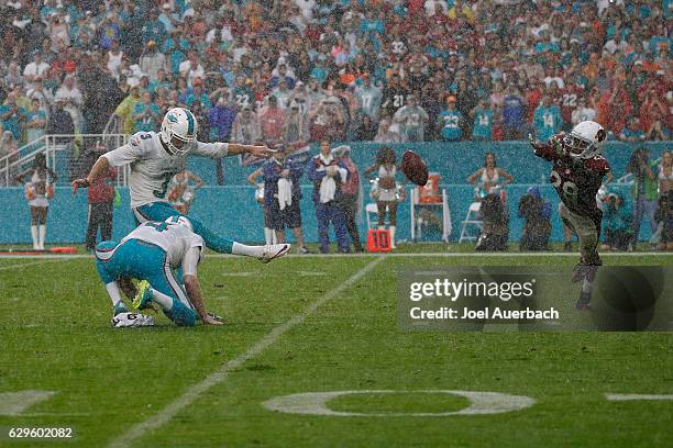 Andrew Franks of the Miami Dolphins kicks the game winning field goal with one second on the clock as Justin Bethel of the Arizona Cardinals is...