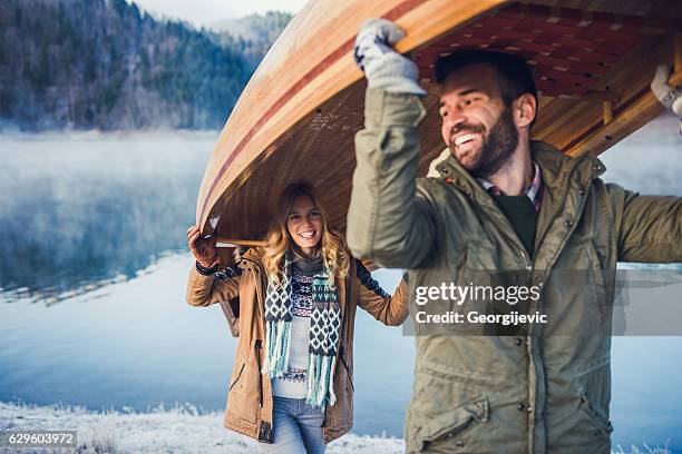 ready for an adventure - two people canoeing on a lake stock pictures, royalty-free photos & images