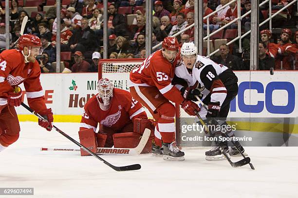 Detroit Red Wings defenseman Alexey Marchenko, of Russia, defends against Arizona Coyotes forward Christian Dvorak in front of the net while Detroit...