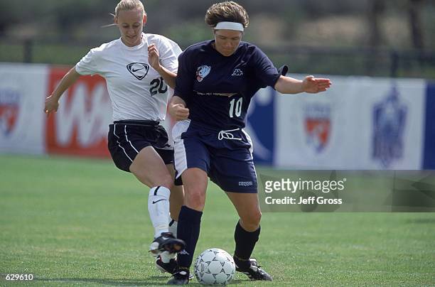 Krista Davey of the D.C. Freedom fights for the ball against Hege Riise of the Carolina Courage during the Spring Training game at the Arco Olympic...