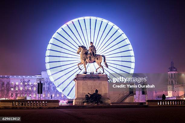 the big wheel at night during the festival of lights in lyon, france - lyon photos et images de collection