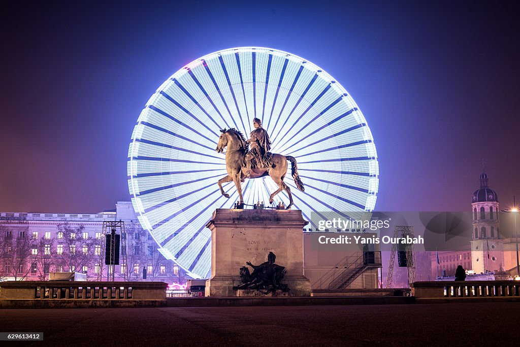 The big wheel at night during the Festival of Lights in Lyon, France