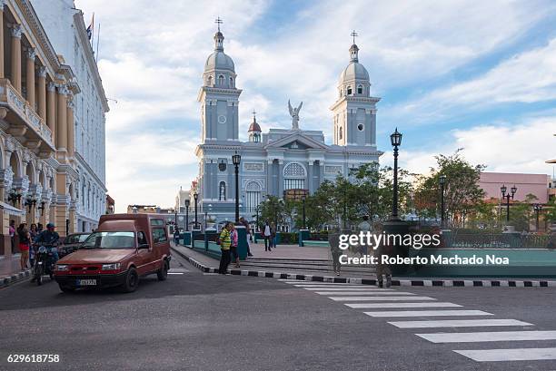 Cathedral Our Lady of Asuncion in the Cespedes plaza. Diverse transportation means moving in the city. The church and old cars are a major tourist...