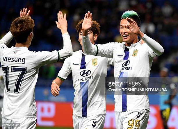 Jeonbuk Hyundai forward Kim Shin-Wook celebrates his goal with midfielder Lee Jae-Sung during the Club World Cup football fifth place match between...