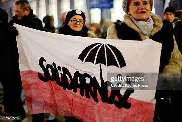 The protesters holds a sign that reads, "Solidarity" during a demonstration organized by the Committee for the Defense of Democracy in opposition to...