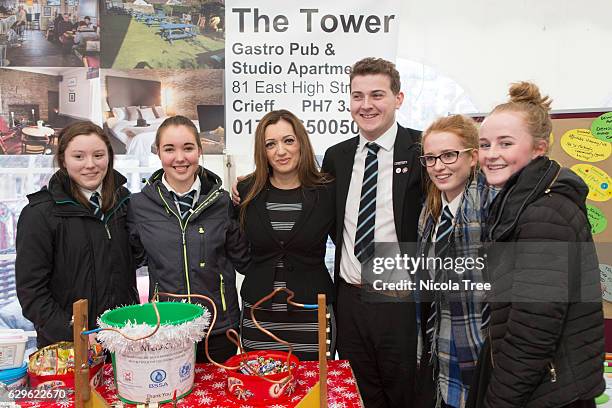 Tasmina Ahmed-Sheikh SNP MP for Ochil and South Perthshire poses with local students as she visits a Christmas market in part of her constituency on...