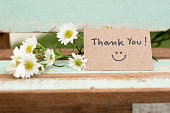 Thank you note with smile face and flower cluster