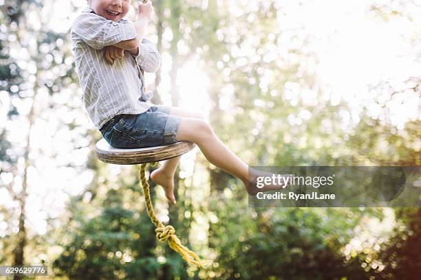 cute boy on rope swing - rope swing stock pictures, royalty-free photos & images