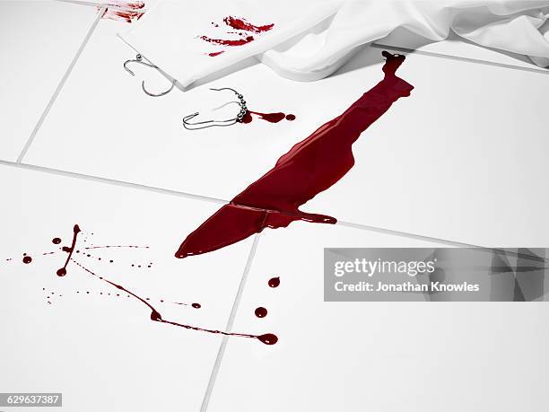 knife shaped blood stain on a white tiled floor. - bloody knife stockfoto's en -beelden