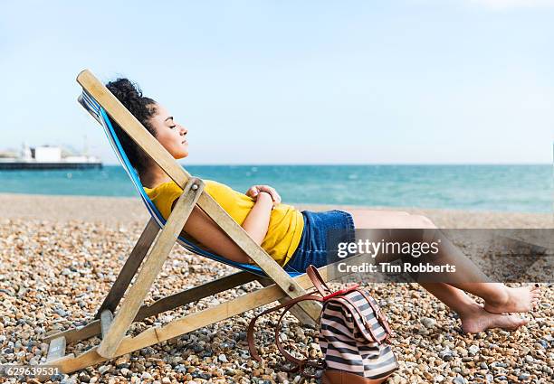 woman relaxing at beach. - deck chair 個照片及圖片檔