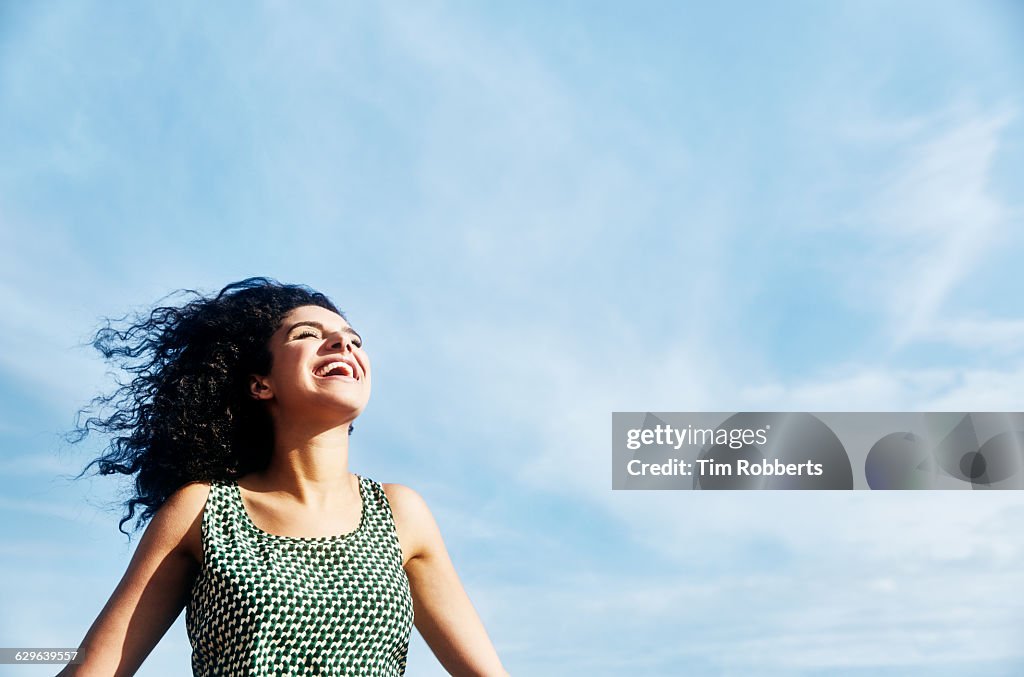 Smiling woman with sky