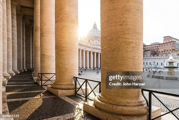 columns of st. peter's basilica, rome, italy - kolonnade stock-fotos und bilder