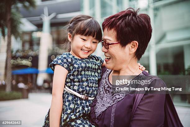 little girl talking joyfully with her grandma - hong kong grandmother stock pictures, royalty-free photos & images