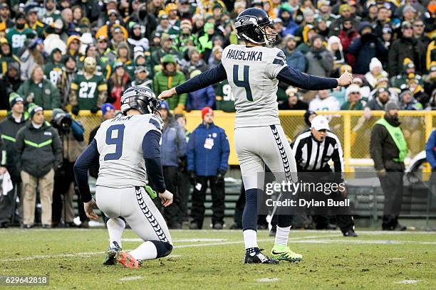 Steven Hauschka of the Seattle Seahawks kicks a field goal as Jon Ryan holds in the first quarter against the Green Bay Packers at Lambeau Field on...