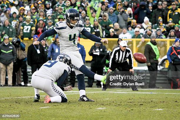 Steven Hauschka of the Seattle Seahawks kicks a field goal as Jon Ryan holds in the first quarter against the Green Bay Packers at Lambeau Field on...