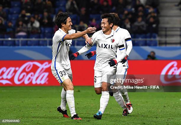 Yasushi Endo of Kashima Antlers celebrates scoring his sides second goal with team mates during the FIFA Club World Cup Semi Final match between...