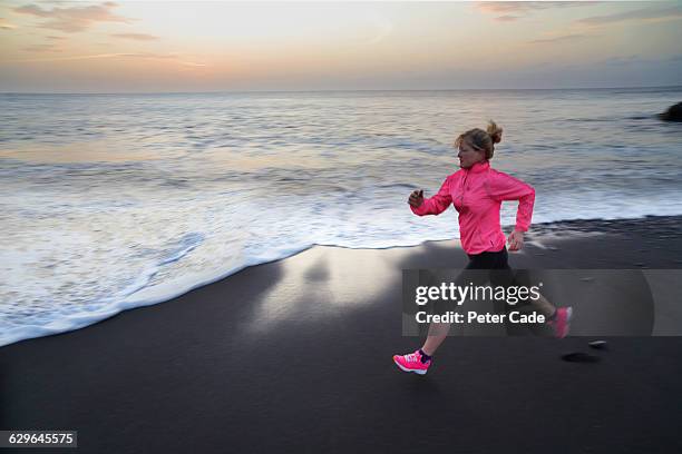 woman running on beach - cropped trousers stock pictures, royalty-free photos & images